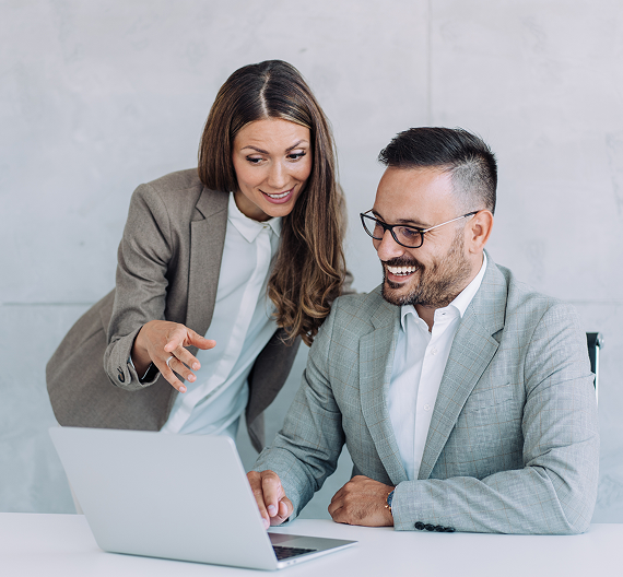 Business professionals reviewing information together on a laptop