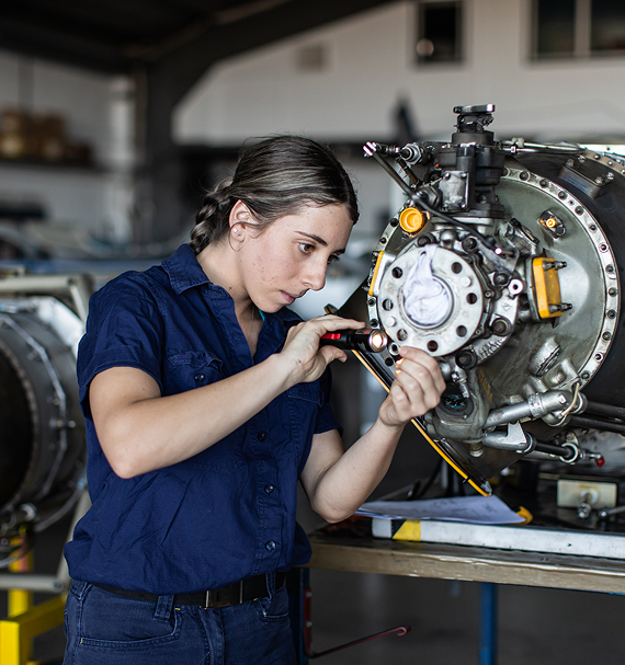 Engineering technician inspecting and maintaining industrial equipment