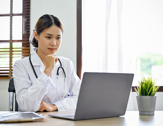 Healthcare professional reviewing information on a computer
