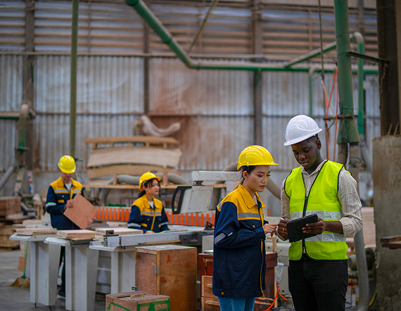 Industrial workers conducting a safety inspection inside a manufacturing facility