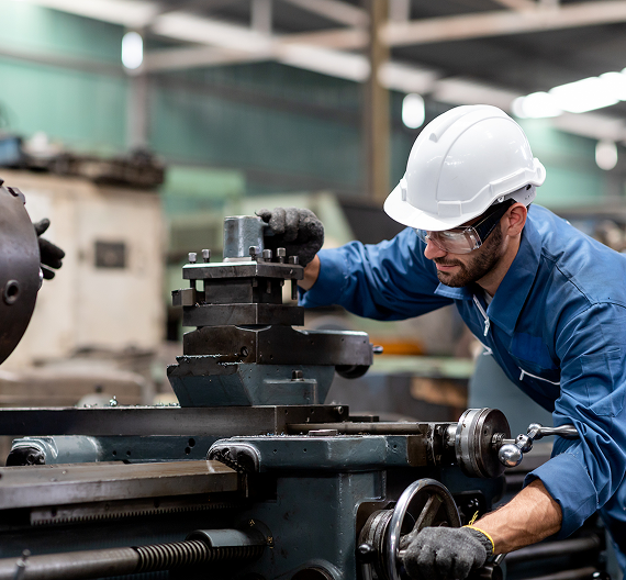 Skilled industrial worker operating machinery in a manufacturing facility