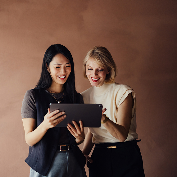 Two professionals reviewing project information on a digital device