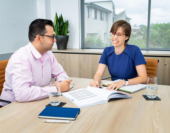 Business professionals discussing documents during a meeting