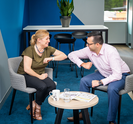 Business professionals having an informal discussion in an office