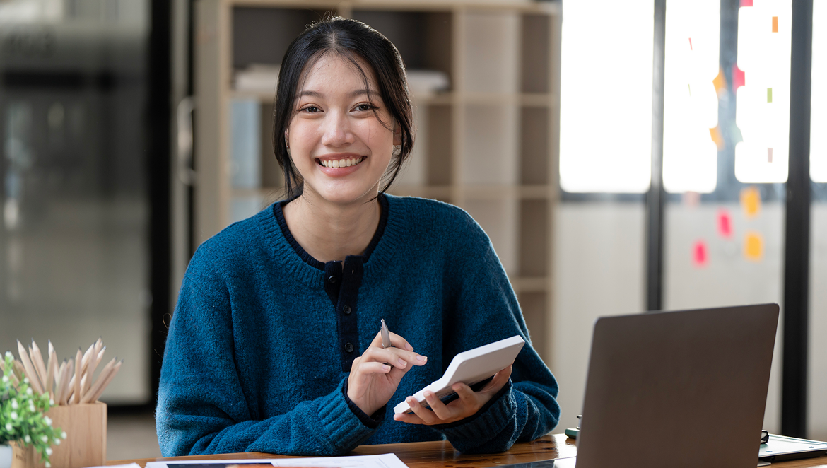 Professional woman working with a tablet and laptop in an office